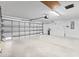 Spacious garage with a high ceiling, bright lighting, and ample room for parking and storage at 16950 Se 80Th Bellavista Cir, The Villages, FL 32162