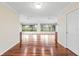 Hallway with hardwood floors and large windows providing natural light to the living space at 16950 Se 80Th Bellavista Cir, The Villages, FL 32162
