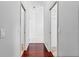 Hallway with wood floors and white walls at 16950 Se 80Th Bellavista Cir, The Villages, FL 32162