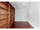 Home office featuring hardwood floors, ceiling fan, crown moulding, and a built-in bookshelf at 16950 Se 80Th Bellavista Cir, The Villages, FL 32162