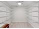 Walk-in closet with carpet and adjustable shelving for optimal storage and organization at 16950 Se 80Th Bellavista Cir, The Villages, FL 32162