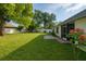Backyard with lush lawn, screened in porch and mature trees at 1784 Providence Blvd, Deltona, FL 32725