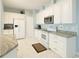 Bright kitchen featuring white cabinetry, stainless steel appliances, and granite countertops at 1784 Providence Blvd, Deltona, FL 32725