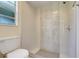Updated bathroom featuring a tile shower enclosure with modern fixtures and bright natural light at 1920 Dardanelle Dr, Orlando, FL 32808