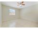 This bedroom has a ceiling fan, ceramic tile floor, and a large window for natural light at 1920 Dardanelle Dr, Orlando, FL 32808