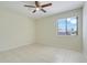 This bedroom has a ceiling fan, ceramic tile floor, and a large window for natural light at 1920 Dardanelle Dr, Orlando, FL 32808