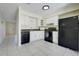Cozy kitchen with white cabinets, black appliances, tile flooring, and a sink with dark countertops at 1920 Dardanelle Dr, Orlando, FL 32808