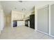 Well-lit kitchen featuring tile flooring, white cabinets, black appliances, and a convenient layout at 1920 Dardanelle Dr, Orlando, FL 32808