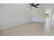 Spacious living area with tile flooring, ceiling fan, and white walls, offering a versatile layout at 1920 Dardanelle Dr, Orlando, FL 32808