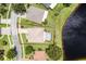 Aerial view of the property with a screened in pool and a large backyard with lake access at 2085 Stone Cross Cir, Orlando, FL 32828