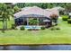 Beautiful backyard view showcasing the screened-in pool and well-maintained lawn extending to the water at 2085 Stone Cross Cir, Orlando, FL 32828