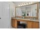 Bathroom vanity with granite countertop, wooden cabinets, and decorative framed mirror at 2085 Stone Cross Cir, Orlando, FL 32828