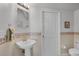 Bathroom featuring a pedestal sink, decorative mirror, and white door at 2085 Stone Cross Cir, Orlando, FL 32828