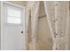 A tiled shower featuring a floral shower curtain and an access door at 2085 Stone Cross Cir, Orlando, FL 32828