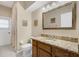 Neutral bathroom featuring a granite countertop, wood cabinets, and tile flooring at 2085 Stone Cross Cir, Orlando, FL 32828