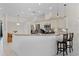 Well-lit kitchen featuring a breakfast bar, stainless steel appliances, and white cabinetry at 2085 Stone Cross Cir, Orlando, FL 32828