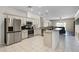 Bright kitchen with stainless steel appliances, and an open view into the living area at 2085 Stone Cross Cir, Orlando, FL 32828