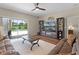 Cozy living room with hardwood floors, ceiling fan, and sliding door access to a pool at 2085 Stone Cross Cir, Orlando, FL 32828