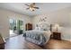 Comfortable main bedroom with hardwood floors and a sliding glass door to outdoor patio at 2085 Stone Cross Cir, Orlando, FL 32828