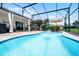 Screened-in pool area featuring lounge chairs and a fountain at 2085 Stone Cross Cir, Orlando, FL 32828
