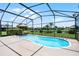 Inviting screened-in pool with surrounding landscaping and a clear blue sky overhead at 2085 Stone Cross Cir, Orlando, FL 32828