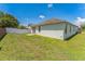 Spacious backyard with well-maintained lawn, white fence, and sliding glass door at 2110 Mallard Creek Cir, Kissimmee, FL 34743