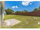 A large yard, concrete slab, and a brick fence on the property line at 2110 Mallard Creek Cir, Kissimmee, FL 34743