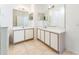 Spacious bathroom featuring double vanities, white cabinets, and tile flooring at 2110 Mallard Creek Cir, Kissimmee, FL 34743