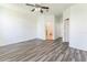 Open bedroom featuring wood flooring, a ceiling fan, and an ensuite bathroom at 2110 Mallard Creek Cir, Kissimmee, FL 34743