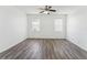 Spacious bedroom featuring wood flooring, a ceiling fan, and natural lighting at 2110 Mallard Creek Cir, Kissimmee, FL 34743