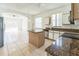 Bright kitchen with island, granite countertops, white cabinets and open to living space at 2110 Mallard Creek Cir, Kissimmee, FL 34743