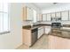Bright kitchen with white cabinets, stainless steel appliances, and granite countertops at 2110 Mallard Creek Cir, Kissimmee, FL 34743