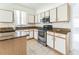 Well-lit kitchen featuring white cabinets, stainless steel appliances, and granite countertops at 2110 Mallard Creek Cir, Kissimmee, FL 34743