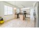 Spacious kitchen featuring an island, white cabinets, stainless appliances, and tile flooring at 2110 Mallard Creek Cir, Kissimmee, FL 34743