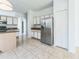 Spacious kitchen with stainless steel refrigerator, granite countertops, and white cabinetry at 2110 Mallard Creek Cir, Kissimmee, FL 34743