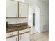 Kitchen featuring granite countertops and white cabinets, open to hallway at 2110 Mallard Creek Cir, Kissimmee, FL 34743