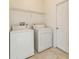 Functional laundry room with washer, dryer, and ample space for sorting and folding at 2110 Mallard Creek Cir, Kissimmee, FL 34743