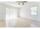 Airy living room with tile floors and large windows creating a bright and open space at 2110 Mallard Creek Cir, Kissimmee, FL 34743