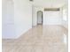 Open living room showcasing neutral paint, tile floors, and archway to adjoining spaces at 2110 Mallard Creek Cir, Kissimmee, FL 34743