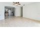 Bright open living room featuring tile floors and access to the adjacent kitchen at 2110 Mallard Creek Cir, Kissimmee, FL 34743