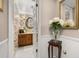Charming powder room featuring wallpaper, a decorative mirror, and a lovely vanity at 2208 Mcmahon Ct # 1033, Orlando, FL 32812