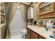 Bathroom featuring a vanity with a marble countertop, complemented by a decorative mirror and patterned wallpaper at 2208 Mcmahon Ct # 1033, Orlando, FL 32812