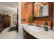 Bathroom featuring a wood vanity with decorative mirror, and a glimpse of the connected bedroom at 2208 Mcmahon Ct # 1033, Orlando, FL 32812