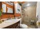 Bathroom with a glass-enclosed shower, vanity, and a decorative mirror, enhanced by bright lighting at 2208 Mcmahon Ct # 1033, Orlando, FL 32812