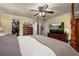 A bedroom featuring a four-poster bed, television, and a view into the walk-in closet at 2208 Mcmahon Ct # 1033, Orlando, FL 32812