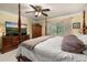 Spacious bedroom featuring a four-poster bed, a ceiling fan, and a large-screen television on a dresser at 2208 Mcmahon Ct # 1033, Orlando, FL 32812