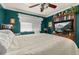 Bedroom featuring a TV on a wooden entertainment center across from a bed with emerald walls at 2208 Mcmahon Ct # 1033, Orlando, FL 32812
