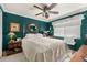Bedroom with a four-poster bed, ceiling fan, and a window dressed with blinds and a white valance at 2208 Mcmahon Ct # 1033, Orlando, FL 32812