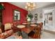 Charming dining room with wood table, ornate mirror, and view into the kitchen at 2208 Mcmahon Ct # 1033, Orlando, FL 32812
