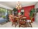 Cozy dining area with wood table, chandelier, and access to the outdoor patio at 2208 Mcmahon Ct # 1033, Orlando, FL 32812